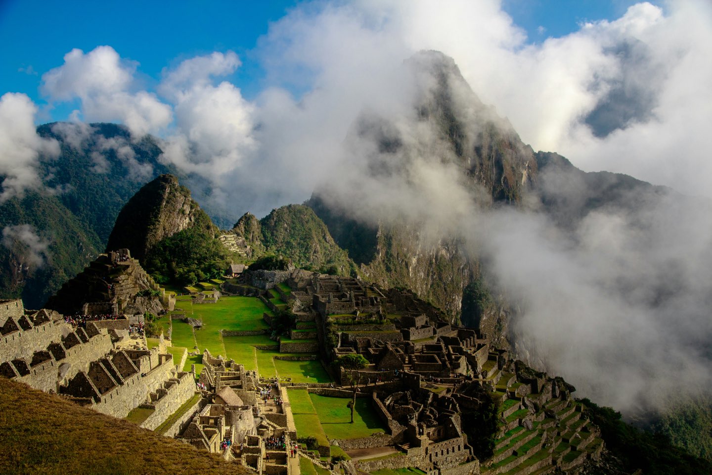 Machu Picchu ancient ruins emerging through dramatic mountain clouds