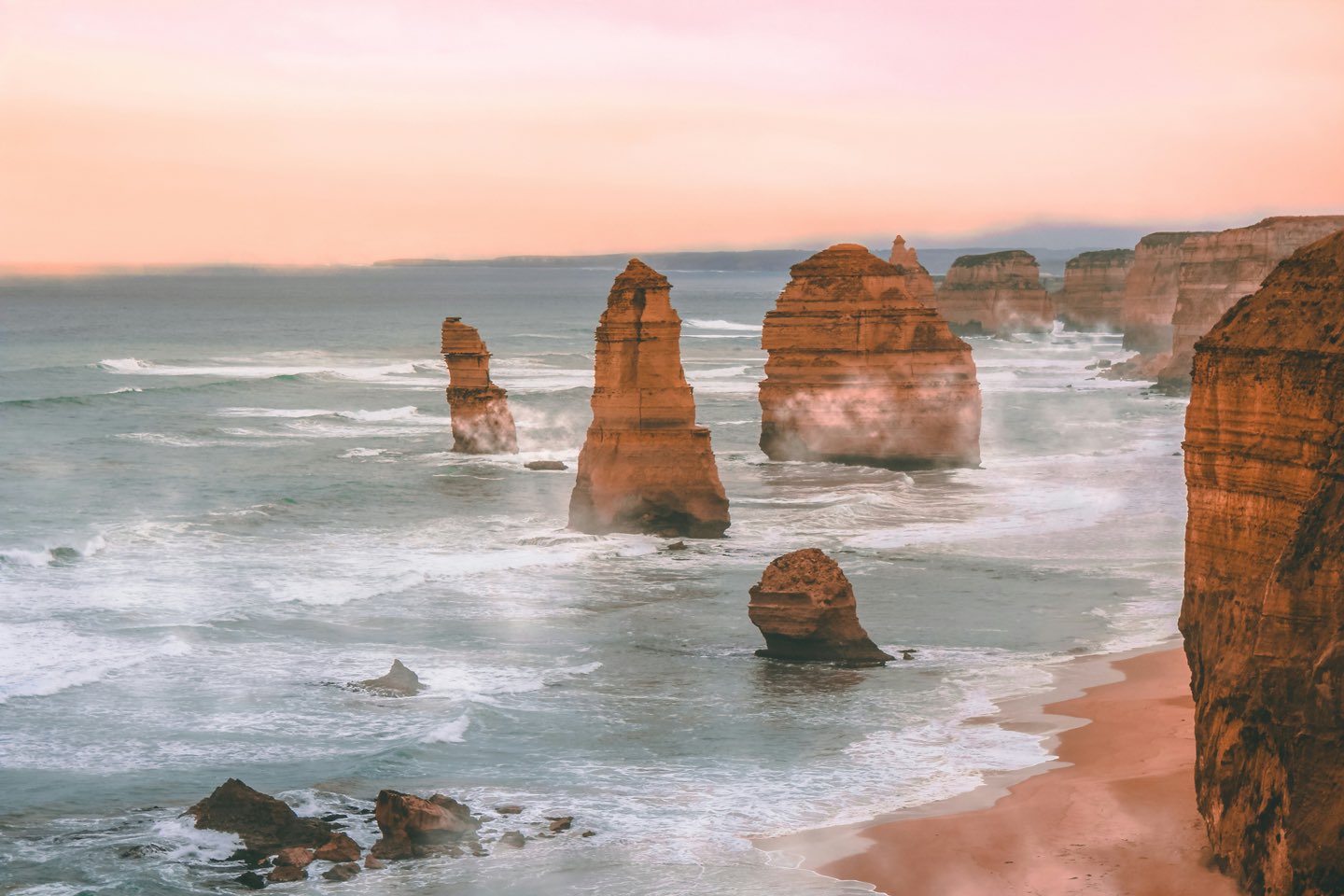 Limestone sea stacks rising from the surf along Australia's Great Ocean Road at sunrise